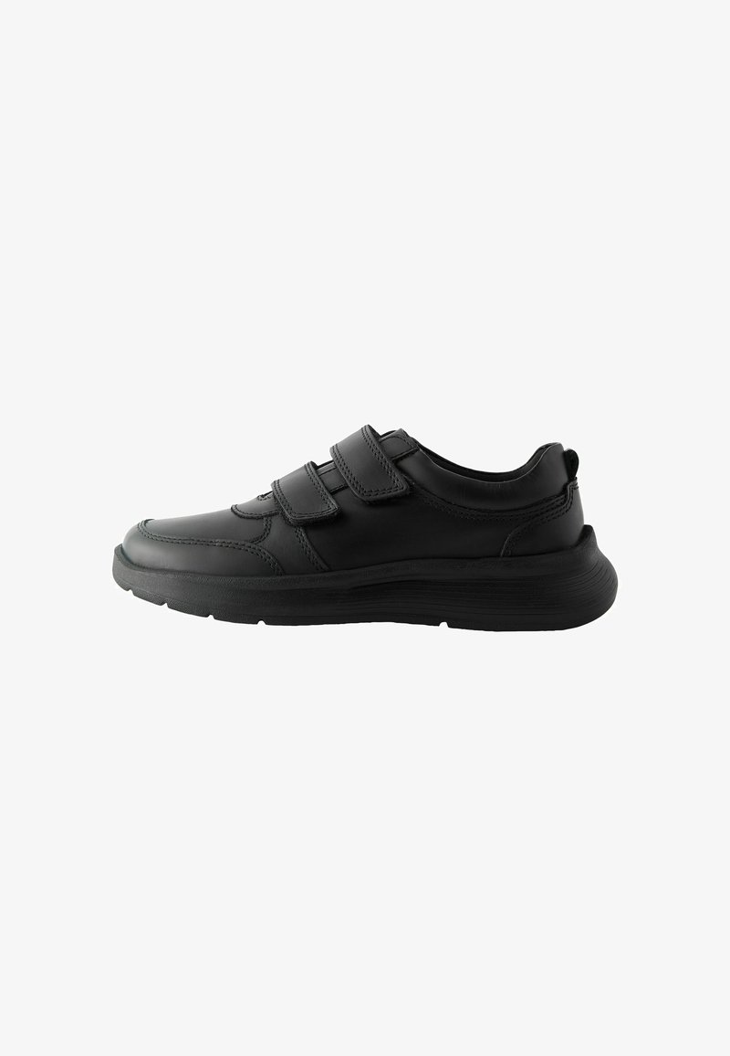 Black athletic shoes with a smooth leather upper, featuring two adjustable velcro straps, rounded toe, and a textured rubber sole.