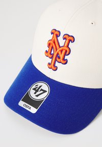 White and blue baseball cap with an embroidered orange 'NY' logo, featuring a solid blue brim and a tag marking size as OSFA.