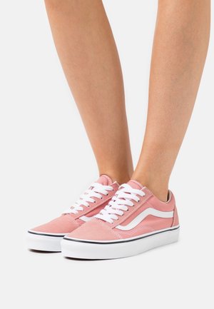 Rosa segelskor i kanvas med vita snören, vita sidostraffar och en gummisula med en svart accentlinje längs kanten.