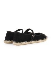 Zapatos de estilo Mary Jane en ante negro con hebilla, que cuentan con una suela de esparto de yute y un diseño de punta redondeada.