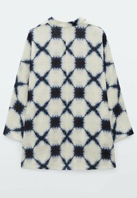 Light fabric long-sleeve garment featuring a cream and dark blue geometric tie-dye pattern, with a relaxed fit and round neck.