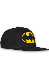 Black baseball cap featuring a prominent yellow Batman logo embroidered on the front. The cap has a flat brim and a textured fabric surface.