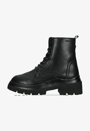 Black leather ankle boots with a rounded toe, lace-up front, and thick, textured rubber sole. Branding on the side seam.