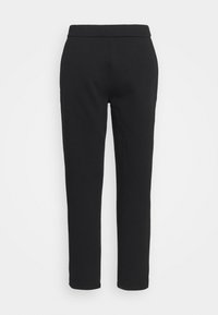 Svarta träningsbyxor i stretch med en slät yta, som har en figurnära design och elastisk midja. Benen smalnar av ner till ankellängd.