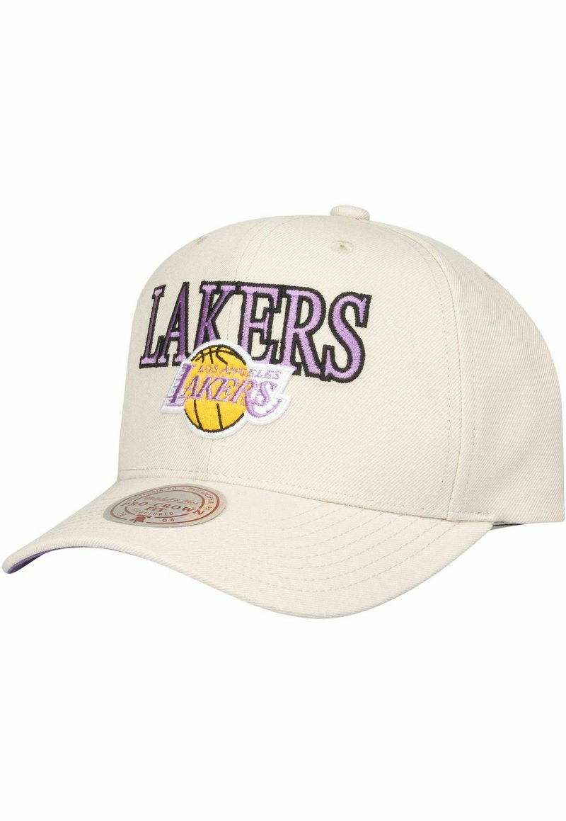 Beige baseball cap with embroidered "LAKERS" text in purple, featuring a basketball graphic. Smooth fabric, curved brim, and adjustable back.