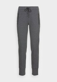 Grå sweatpants i texturerat material, med dragsko i midjan, fickor med dragkedja på sidorna och åtsittande mudd vid anklarna.