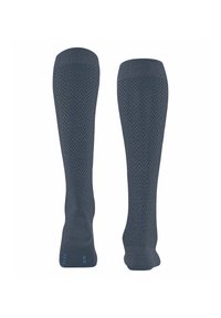 Calze blu scuro al ginocchio con motivo a spina di pesce, bordo a coste e texture liscia. Nota accentuazione blu vicino al tallone.
