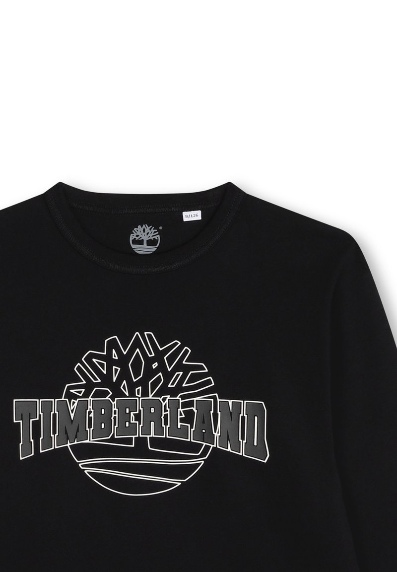 Felpa nera in cotone con un grafico bianco di un logo ad albero e il testo "TIMBERLAND" in lettere maiuscole grasse. Tessuto liscio, scollatura rotonda.