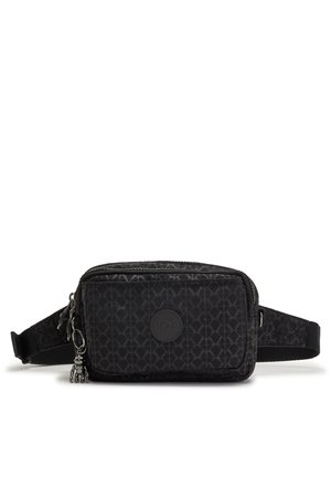 Black fabric waist bag featuring a geometric pattern, zip closure, a circular logo patch, and a decorative charm. Includes an adjustable strap.