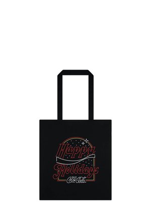 Sort tote bag med rød og hvid tekst "Glædelig Jul", med et rundt design med stjerner og "Nyd Coca-Cola" nederst.
