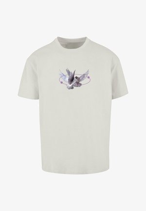 Helehallid lühikeste varrukatega T-särk, millel on üksikasjalik graafika lendavast linnust, ümbritsetud lilla ringikujulise disainiga. Pehme puuvillane materjal.