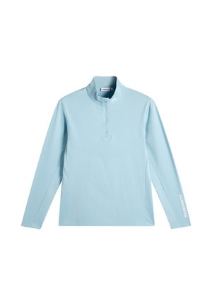 Pull-over à manches longues bleu clair avec une courte fermeture éclair à l'avant et le logo J.LINDEBERG sur la manche gauche et le col.