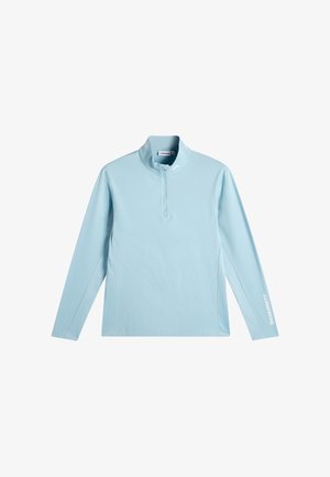 Pull-over à manches longues bleu clair avec une courte fermeture éclair à l'avant et le logo J.LINDEBERG sur la manche gauche et le col.