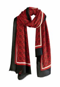 Red scarf with black swirling pattern, bordered in black and ivory. Made of a lightweight, textured fabric, with frayed edges for detail.