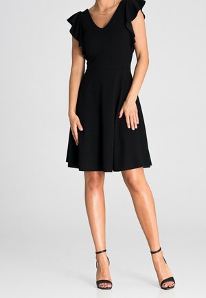 Black dress with ruffled sleeves, V-neckline, fitted waist, and flared skirt. Paired with black heeled sandals, smooth fabric texture.