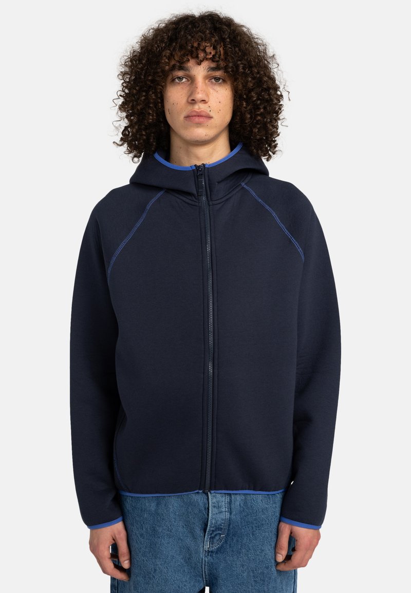Navy zip-up hoodie with a fitted hood, blue accents, and raglan sleeves. Soft texture and casual fit, paired with light blue interior.