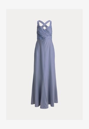 Tengerészkék és fehér csíkos, a padlóig érő ruha átfedő pántokkal és testre simuló, ráncolt felsőrésszel, amely egy bővülő, áramló szoknyába torkollik.