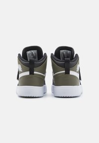 Green and black high-top sneakers featuring a textured finish, white accents, and a pull tab at the heel. Standard rubber sole.