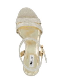 Gold strappy sandal with textured metallic straps, a smooth golden footbed, and ankle strap with adjustable buckle. Brand logo visible.