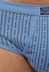 Mutande in cotone blu chiaro con un motivo a strisce orizzontali texturizzate in navy. Vita elasticizzata con etichetta del marchio sul lato.