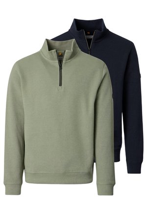 To langærmede trøjer med kvart-lynlås, den ene i olivengrøn foran og den anden i mørkeblå bagved, begge med tekstureret stof og opretstående kraver.