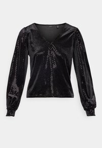 Svart långärmad topp i glänsande tyg med V-ringning; har puffärmar och ett prickigt mönster som reflekterar ljus.