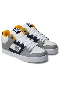 Low-top sneakers with a white leather toe, gray textured body, navy accents, yellow collar, and white laces. Features logo on the side.