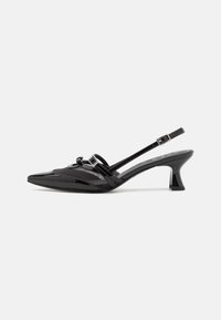 Mustat lakatut slingback-korkokengät, joissa on terävät varpaat, hopeiset solkiyksityiskohdat ja strukturoidut kangaskerrokset vampissa. Kumi-alla.