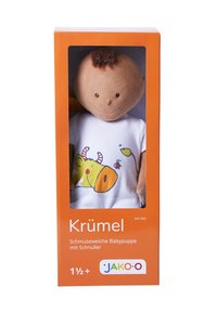 Soft, brown-skinned baby doll in a box; features a white shirt with a yellow cow graphic, orange packaging with clear front. Age 1.5+.