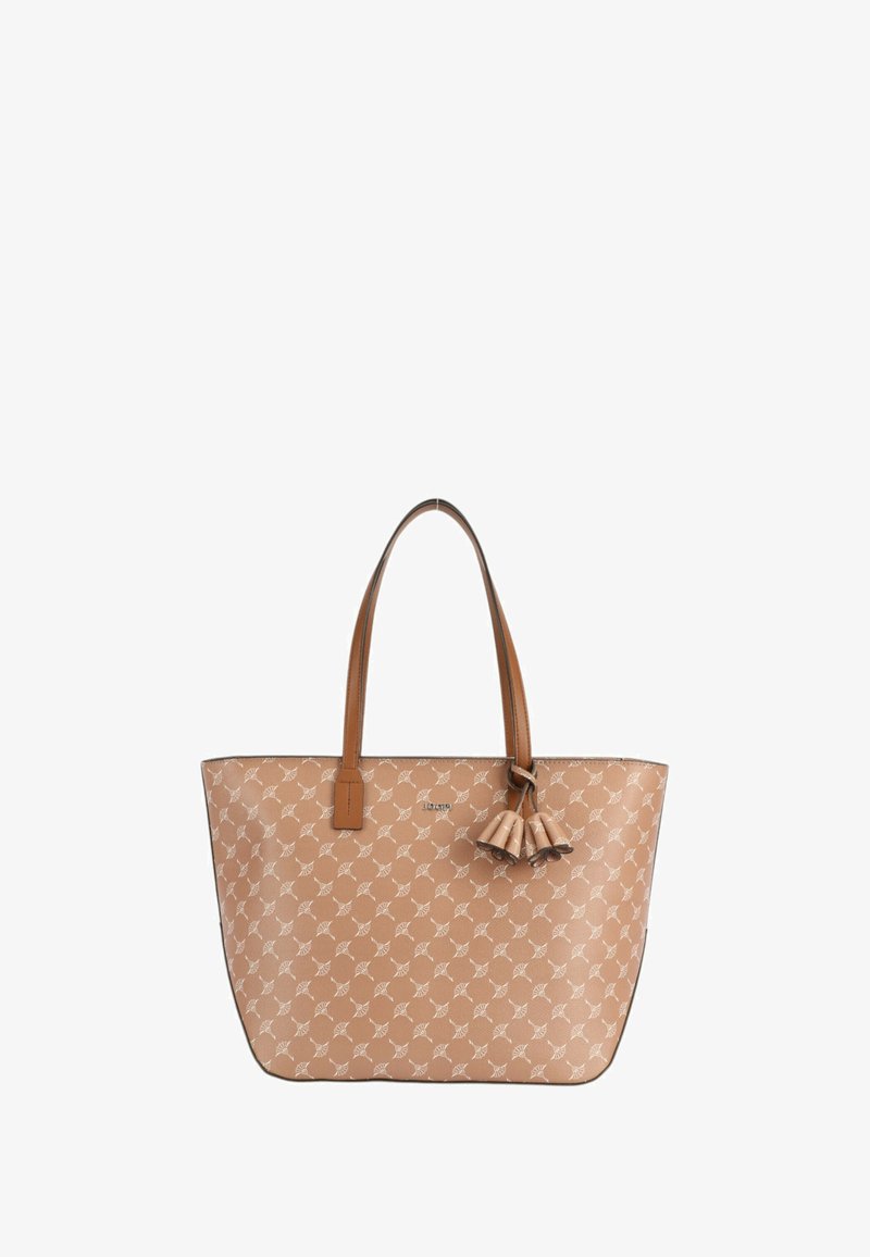 Sac fourre-tout beige avec un motif de feuilles blanches répétées, anses en cuir marron et un pompon décoratif. Présente une texture lisse et une forme structurée.