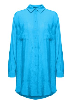 Vaaleansininen, pitkähihainen nappikauluspaita tekstuurimaisella kankaalla. Sisältää kauluksen ja kaksi rintataskua, joissa on kaareva helma.