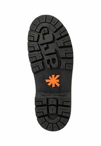 Suela de zapato negra con surcos profundos, con el texto "art" incrustado y un símbolo de asterisco naranja centrado sobre la marca "THE ART COMPANY".