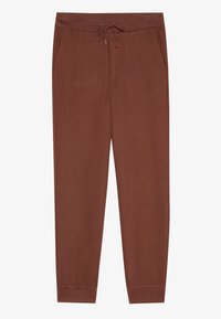 Bruna sweatpants med dragsko i midjan, sidofickor, smalnande ben och mjuk textur. Inga mönster eller accentuationer synliga.