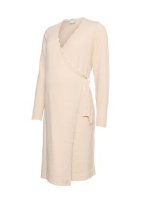 Kermansävyinen kietaisumekko, jossa on pitkät hihat, lovellinen pääntie ja sivulla solmittava kiinnitys. Pehmeä tekstuuri ja polven pituinen malli.