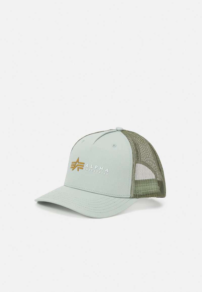 Lys grøn caps med solid front og olivengrøn mesh på siderne. Har "ALPHA INDUSTRIES" logo i guld på forsiden. Buet skygge.