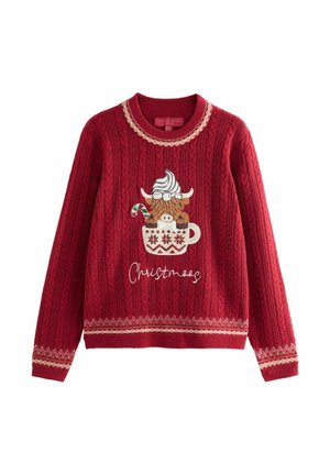 Pull de Noël rouge tricoté avec une vache Highland dans une tasse surmontée de crème chantilly et d’un sucre d’orge, texte « Christmoos » en dessous.