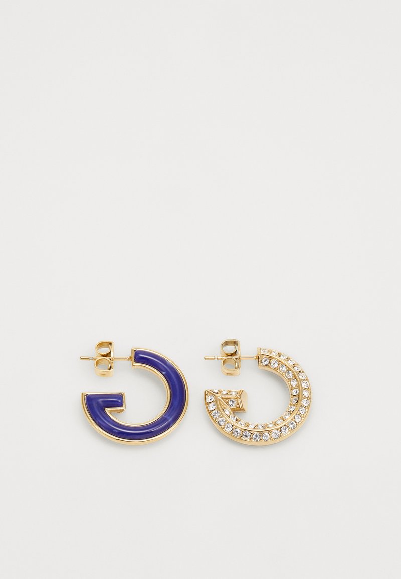 Gold-tone earrings featuring one blue enamel half hoop and one embellished with clear rhinestones on a curved design.