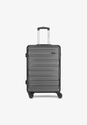 Valigia rigida spinner di colore grigio scuro con scanalature verticali, manico estraibile e quattro ruote per la mobilità. Presenta il logo del marchio sulla parte anteriore.