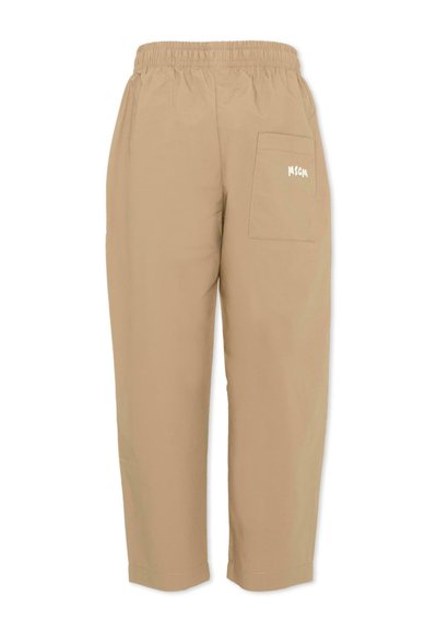 Pantalon beige à taille élastique avec une seule poche arrière sur le côté droit, ornée d'un petit texte imprimé en blanc.