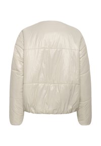 Doudoune beige clair, dotée d'un extérieur matelassé et brillant, d'une silhouette courte et d'un ourlet élastique avec épaules tombantes.