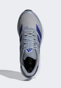 Gray athletic shoe with blue accents, mesh upper, textured finish, lace closure, and rounded toe. Ortholite insole visible on the interior.