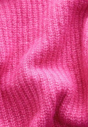 Chunky pink knit textile with a ribbed texture, featuring soft fibers and subtle variations in shade throughout the fabric.