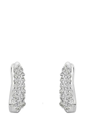 Silver earrings with a wavy design, featuring a row of small, round, sparkling clear crystals set along the front for added shine.