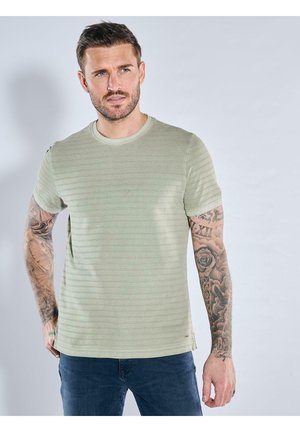 Light green short-sleeve t-shirt with a round neckline, featuring horizontal stripes and a smooth texture. Detailed tattoos on arms.