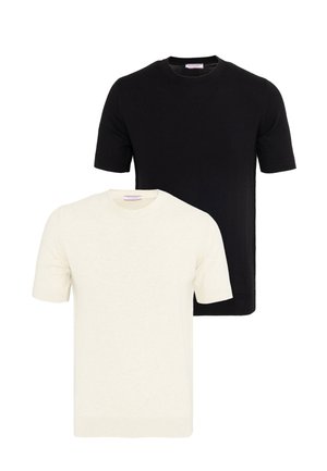 Due maglioni semplici a maniche corte, uno nero e uno panna, esposti su uno sfondo bianco.