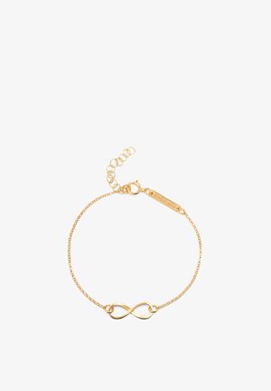 Bracelet plaqué or avec un pendentif en forme de symbole infini. Chaîne délicate avec fermoir ajustable et étiquette gravée "SINGULAR."