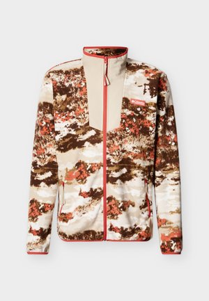 Fleecetröja med ett beige, brunt och orange abstrakt mönster. Har dragkedja framtill, hög krage och sidfickor.