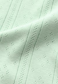 Ljusgrön stickad tyg med en texturerad mönster, som har upphöjda diamantskäl och vertikala ränder. Mjukt och lätt material.