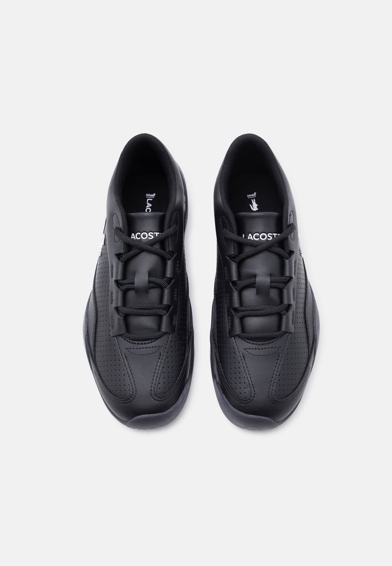 Pair of black Lacoste sneakers with perforated detailing and black laces, viewed from above on a white background.