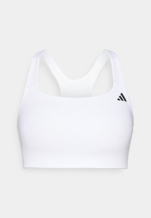 Brassière de sport blanche en tissu lisse et extensible. Présente un design dos nageur et un petit logo noir sur le côté gauche. Aucun système de fermeture visible.
